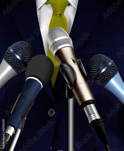 Photo: Man Giving Speech Using Microphones Man Giving Speech Using Microphones