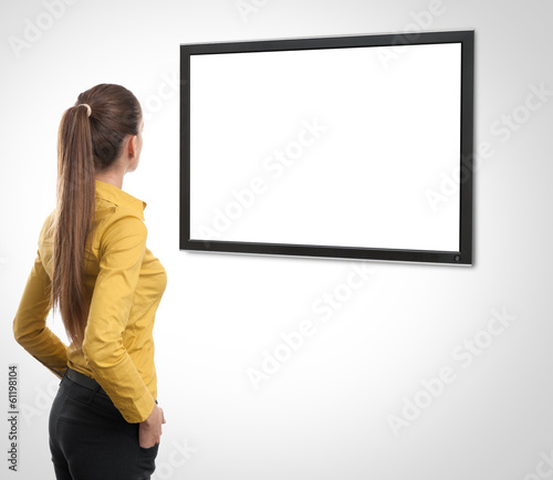 Photo: Business woman looking at tv Business woman looking at tv