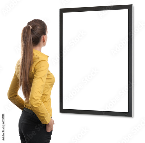Photo: Business woman from the back looking at tv Business woman from the back looking at tv