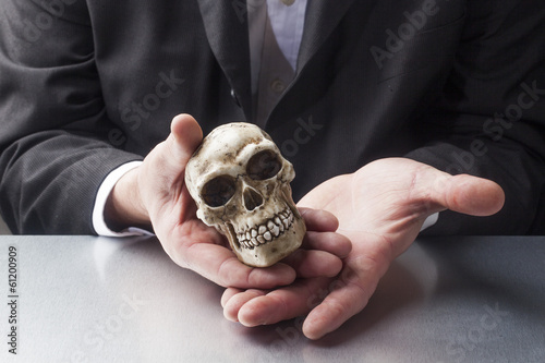 Photo: doctor's hands displaying a skull doctor's hands displaying a skull