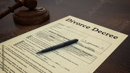 Photo: divorce decree paper with a pen, gavel and rings in the scene divorce decree paper with a pen, gavel and rings in the scene