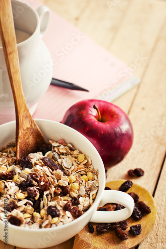 Photo: healthy breakfast background/ bowl of oat flake with raisins healthy breakfast background/ bowl of oat flake with raisins