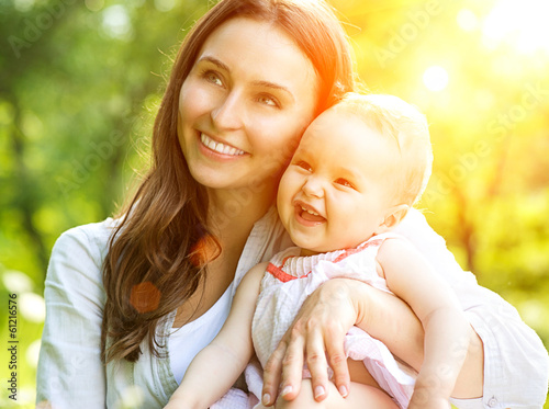 Photo: Beautiful Mother And Baby Outdoors. Nature Beautiful Mother And Baby Outdoors. Nature