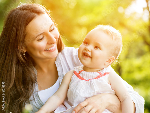 Photo: Beautiful Mother And Baby Outdoors. Nature Beautiful Mother And Baby Outdoors. Nature