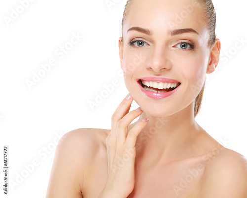 Photo: Young woman touching her face isolated on white background. Young woman touching her face isolated on white background.