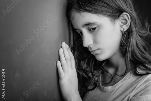 Photo: Grunge black and white portrait of a sad teenage girl Grunge black and white portrait of a sad teenage girl