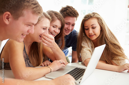 Photo: Group Of Teenagers Gathered Around Laptop Together Group Of Teenagers Gathered Around Laptop Together