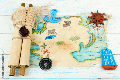 Photo: Treasure map with sea accessories, on wooden background Treasure map with sea accessories, on wooden background