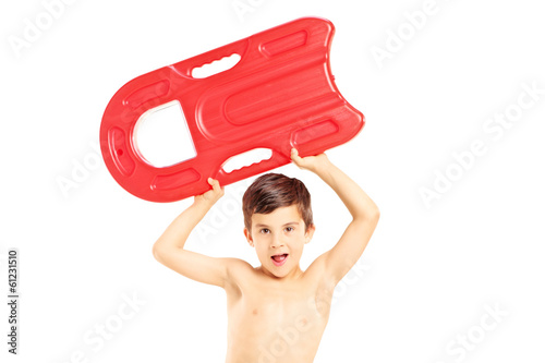 Photo: Boy holding a swimming float and looking at camera Boy holding a swimming float and looking at camera