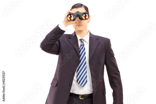 Photo: Male businessman watching through binoculars Male businessman watching through binoculars