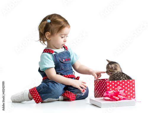 Photo: happy child girl playing with kitten happy child girl playing with kitten