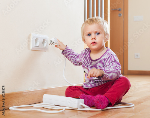 Photo: Baby playing with electrical extension Baby playing with electrical extension