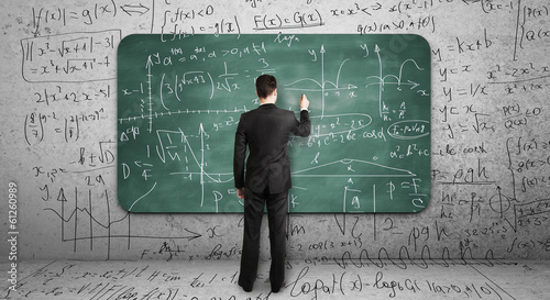 Photo: businssman drawing mathematical formula businssman drawing mathematical formula