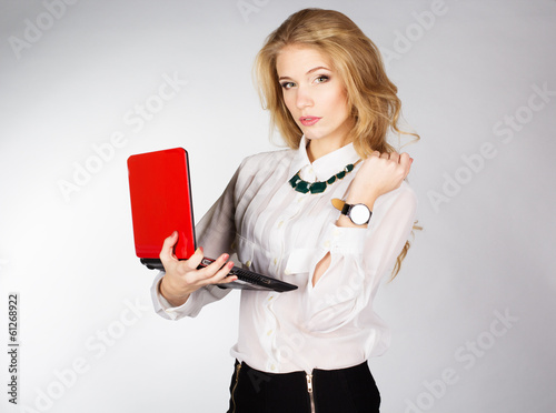 Photo: Portrait of woman with a laptop over white background Portrait of woman with a laptop over white background