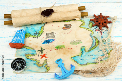 Photo: Treasure map with sea accessories, on wooden background Treasure map with sea accessories, on wooden background