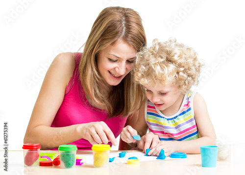 Photo: child and mother play colorful clay toy child and mother play colorful clay toy