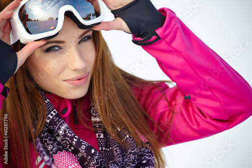 Photo: Happy young caucasian woman wearing ski goggles Happy young caucasian woman wearing ski goggles