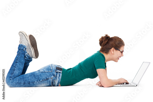 Photo: Teenage girl lying down laptop Teenage girl lying down laptop