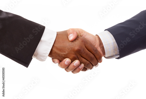 Photo: Handshake between african and a caucasian business man, isolated Handshake between african and a caucasian business man, isolated