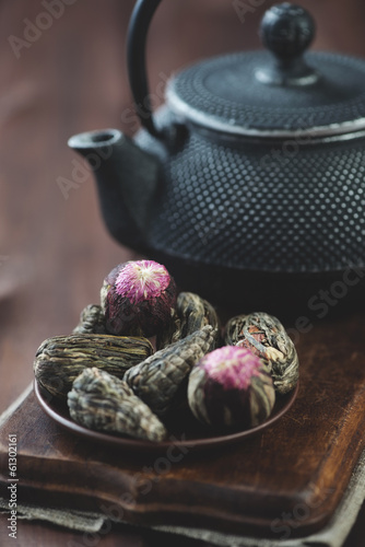 Photo: Green tea balls and asian cast-iron teapot, vertical shot Green tea balls and asian cast-iron teapot, vertical shot