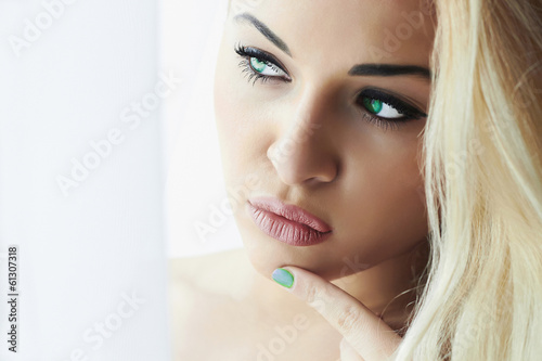 Photo: Beautiful Face of Young Blond Woman.Look in Window Beautiful Face of Young Blond Woman.Look in Window