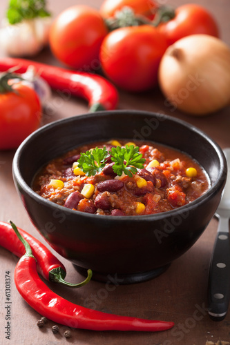 Photo: mexican chili con carne in black plate with ingredients mexican chili con carne in black plate with ingredients