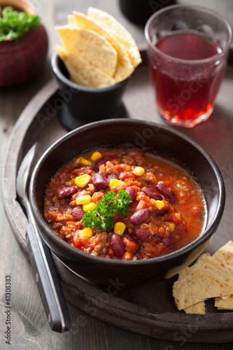 Photo: mexican chili con carne in black bowl with tortilla mexican chili con carne in black bowl with tortilla