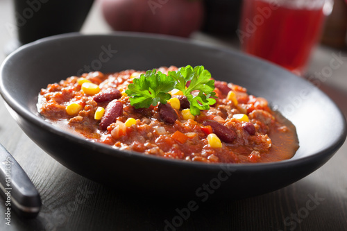 Photo: mexican chili con carne in black plate mexican chili con carne in black plate