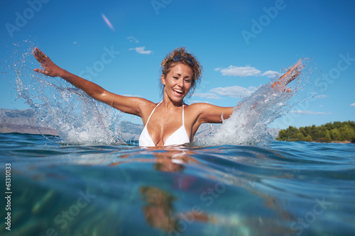 Photo: Happy young woman in sea with open hands. Happy young woman in sea with open hands.