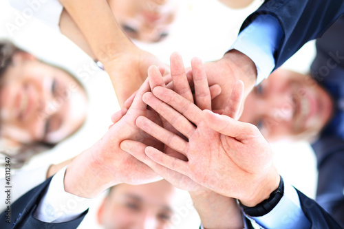 Photo: Small group of business people joining hands Small group of business people joining hands