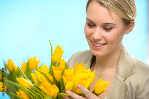 Photo: Woman looking down at spring yellow tulips Woman looking down at spring yellow tulips