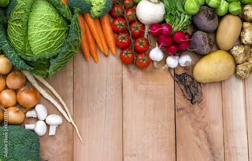 Photo: Organic Vegetables on wooden background Organic Vegetables on wooden background