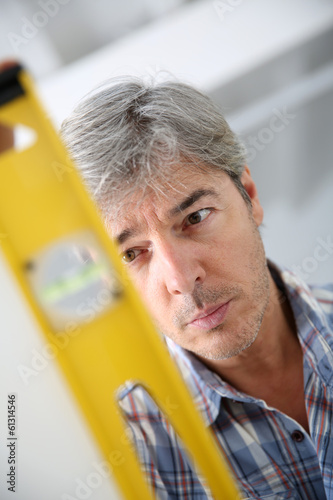 Photo: Closeup of craftsman using level Closeup of craftsman using level
