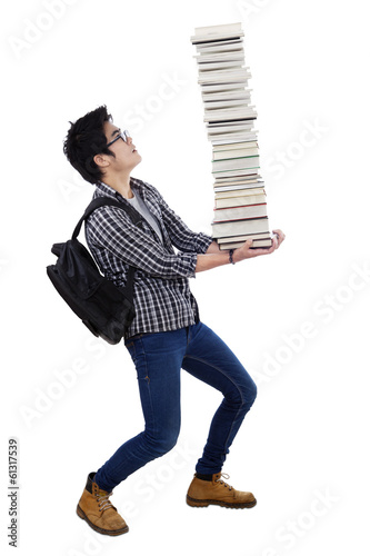 Photo: Man carrying a pile of books Man carrying a pile of books