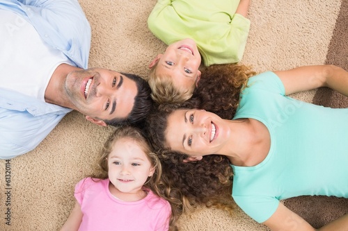 Photo: Happy family lying on the rug in a circle Happy family lying on the rug in a circle
