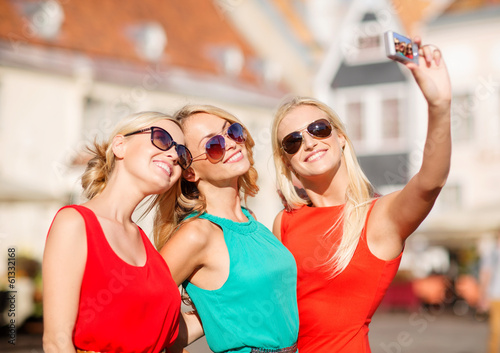 Photo: three beautiful girls taking picture in the city three beautiful girls taking picture in the city