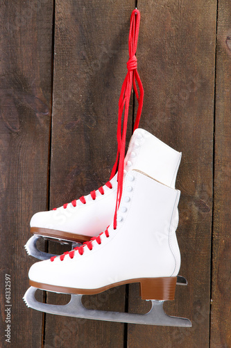 Photo: Figure skates on wooden background Figure skates on wooden background
