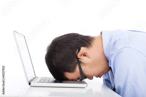 Photo: young businessman too overwork to asleep young businessman too overwork to asleep