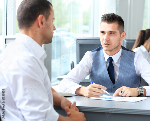 Photo: Happy business people talking on meeting at office Happy business people talking on meeting at office