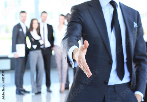 Photo: A business man with an open hand ready to seal a deal A business man with an open hand ready to seal a deal