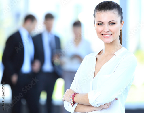 Photo: Face of beautiful woman on the background of business people Face of beautiful woman on the background of business people
