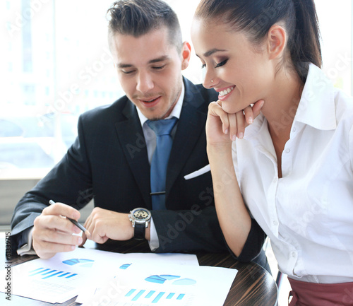 Photo: Happy business people talking on meeting at office Happy business people talking on meeting at office