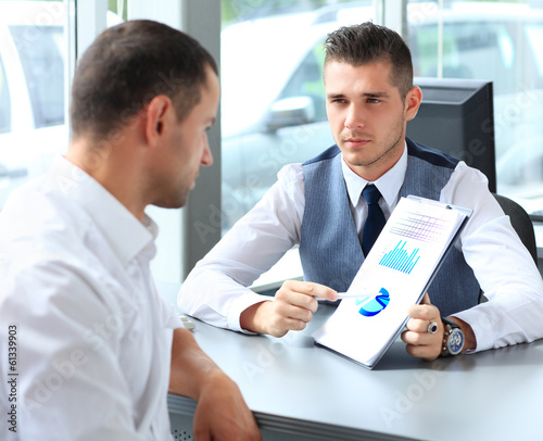 Photo: Happy business people talking on meeting at office Happy business people talking on meeting at office