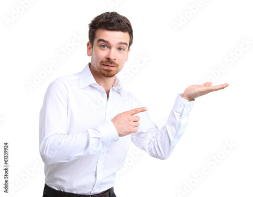 Photo: Business man presenting over a white background Business man presenting over a white background