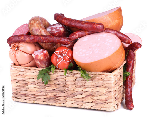 Photo: Lot of different sausages in basket isolated on white Lot of different sausages in basket isolated on white