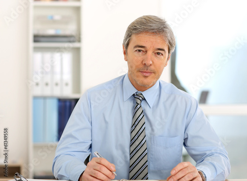 Photo: Portrait of mature businessman in office Portrait of mature businessman in office