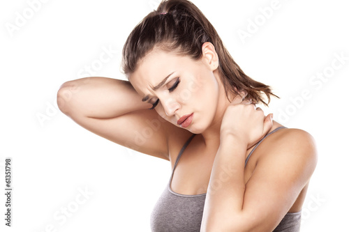 Photo: beautiful young woman has a pain in the neck beautiful young woman has a pain in the neck