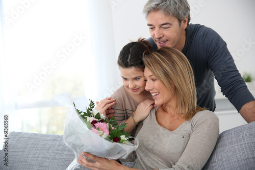 Photo: Family celebrating mother's day with bunch of flowers Family celebrating mother's day with bunch of flowers