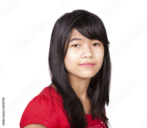 Photo: Preteen biracial girl in red shirt on white background Preteen biracial girl in red shirt on white background