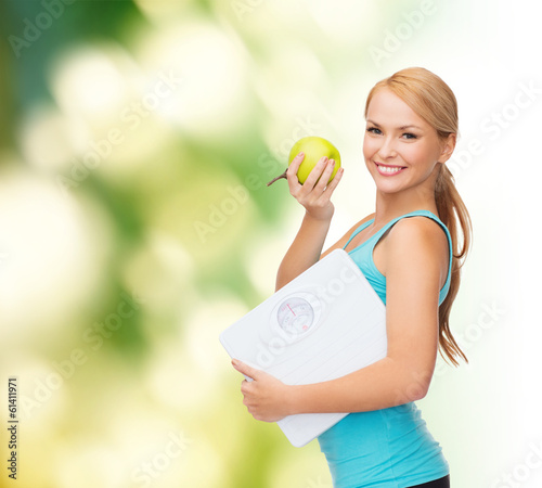 Photo: sporty woman with scale and green apple sporty woman with scale and green apple